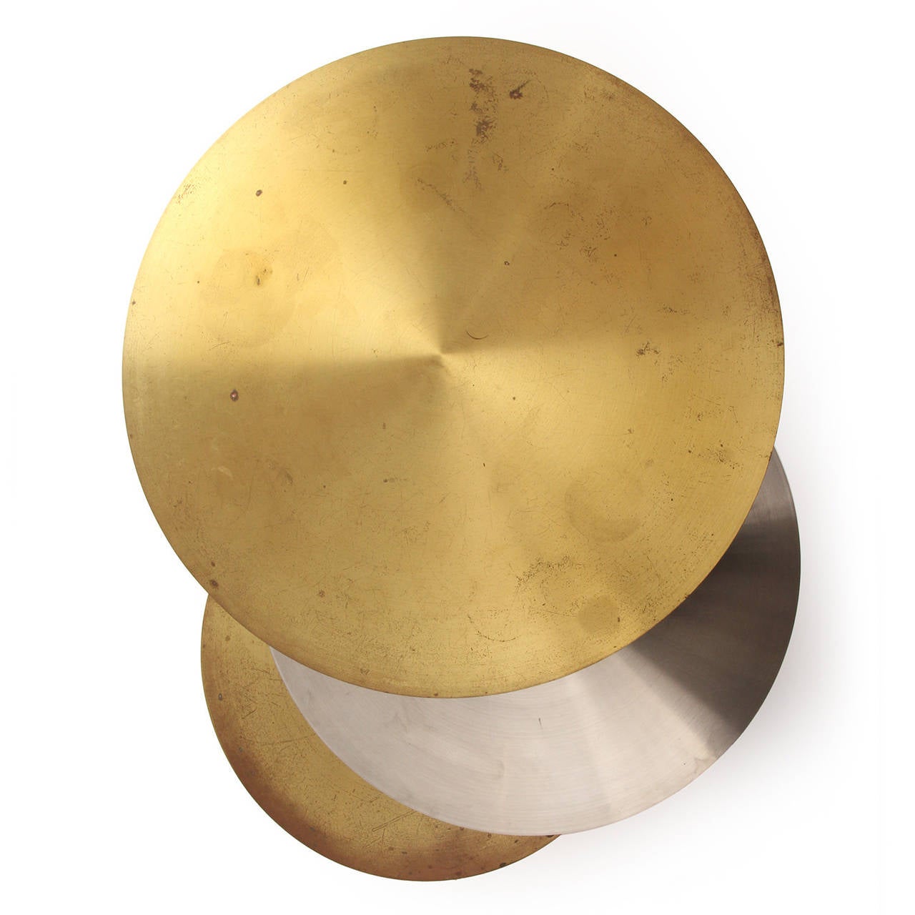 An unusual and superb quality occasional table on casters having three circular planes (two in brass, the center in brushed steel) conjoined by a central steel stem. The top two cantilevered surfaces rotate freely around the steel stem.