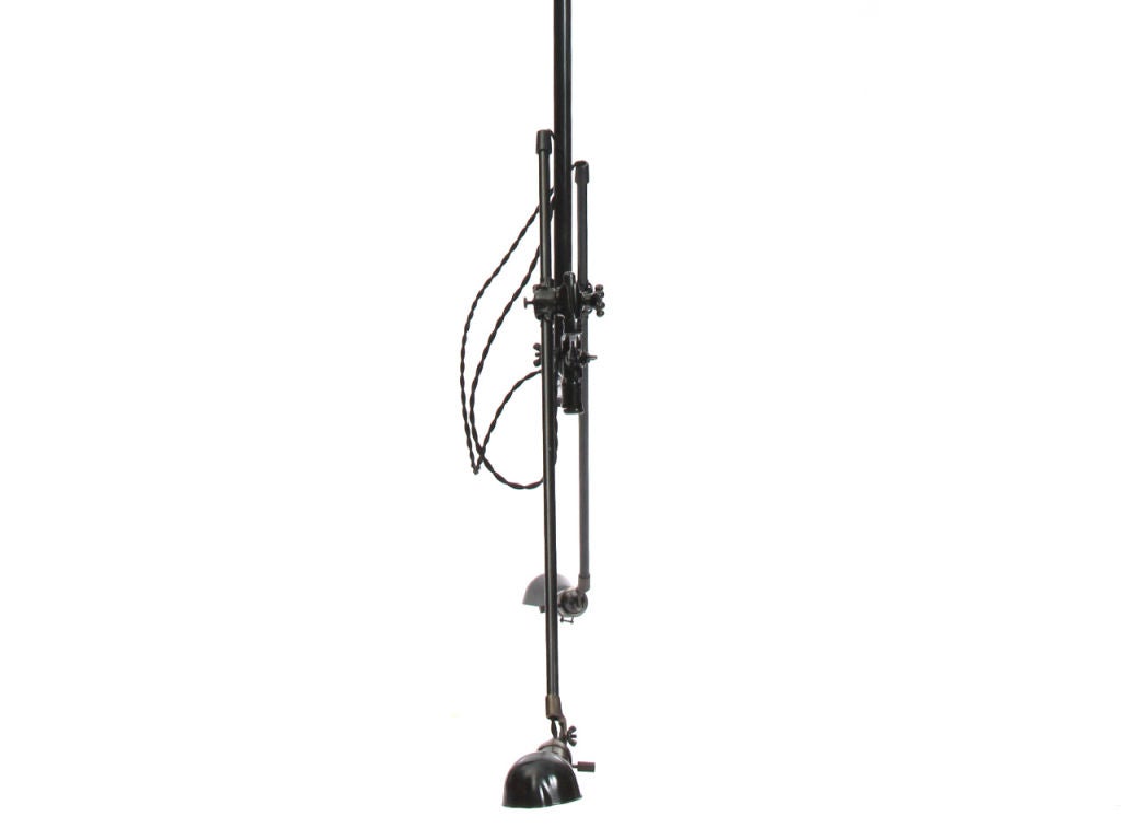 A rare style ceiling fixture with a pair of arms and egg shaped shades finished steel with a black patina. Drop is adjustable. Dimensions provided are fully extended.