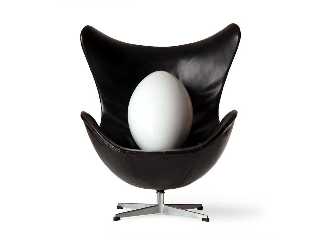 A large white lacquered egg sculpture made of seamless hollow fiberglass. Display pedestal available separately.