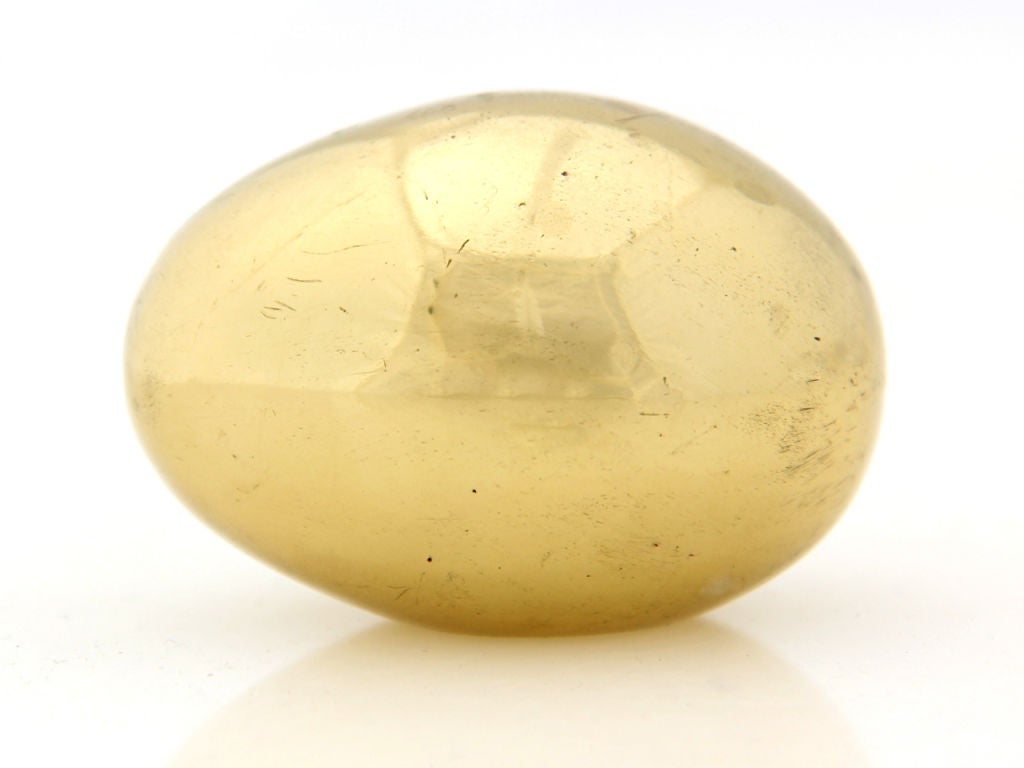 A solid brass paperweight in the form of an egg.