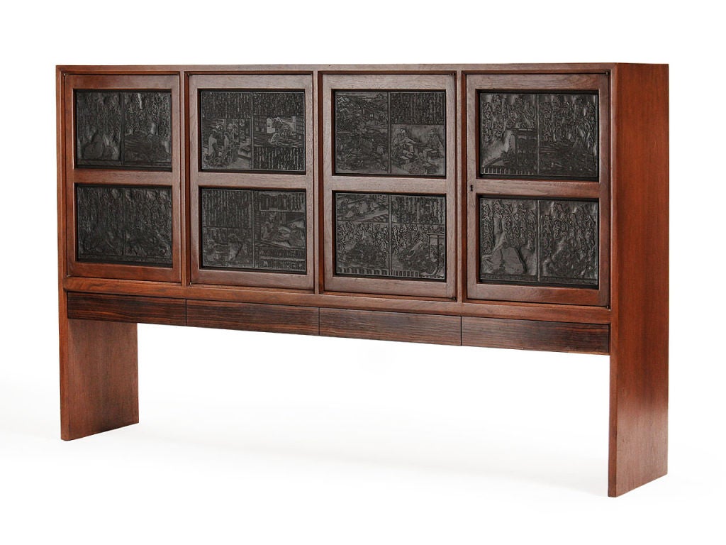 A slab-sided, walnut “Janus” cabinet with four doors – set with antique Japanese printing plates - over four rosewood-front drawers.
