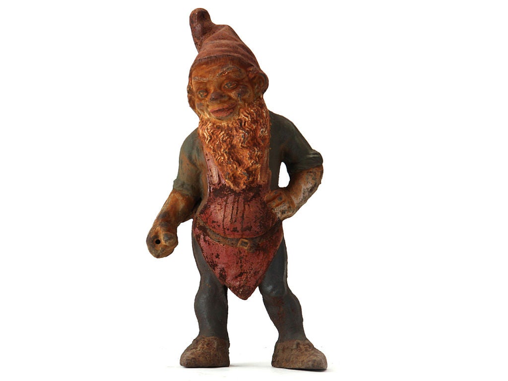 A whimsical statue of a cast-iron garden gnome with original paint.