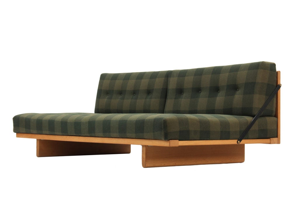 An upholstered daybed with sofa back. Three available, priced individually. Two others have striped upholstery - one with oak frame and one with teak. See also Item 5949 for frame without back.