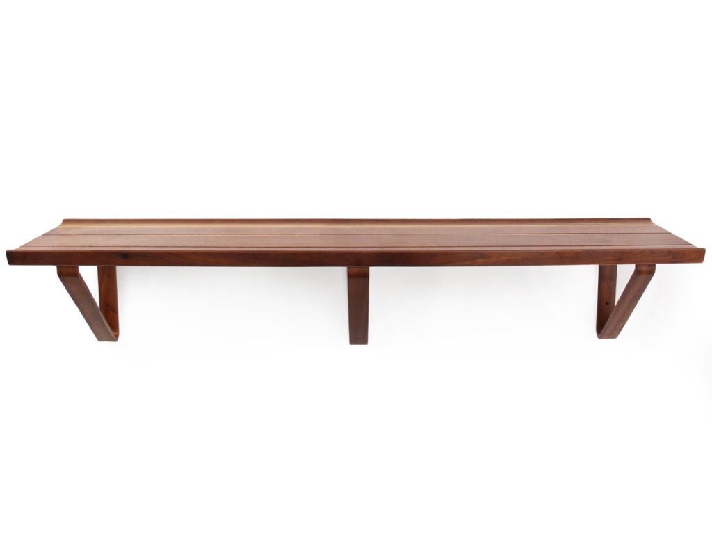 Laminated walnut brackets support a solid walnut top. Shelf retains same details as the'long john' bench. Various sizes and finishes available. made by Dunbar