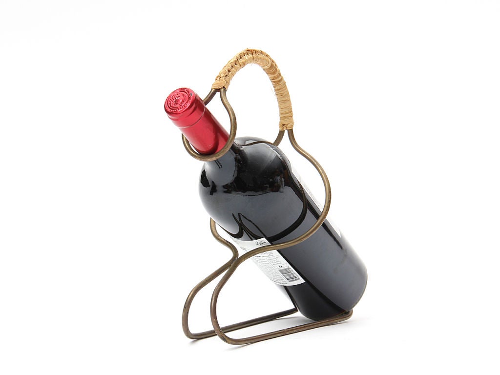 A selection of impeccably rendered brass wine holders with finely wrapped cane handles. Priced individually.