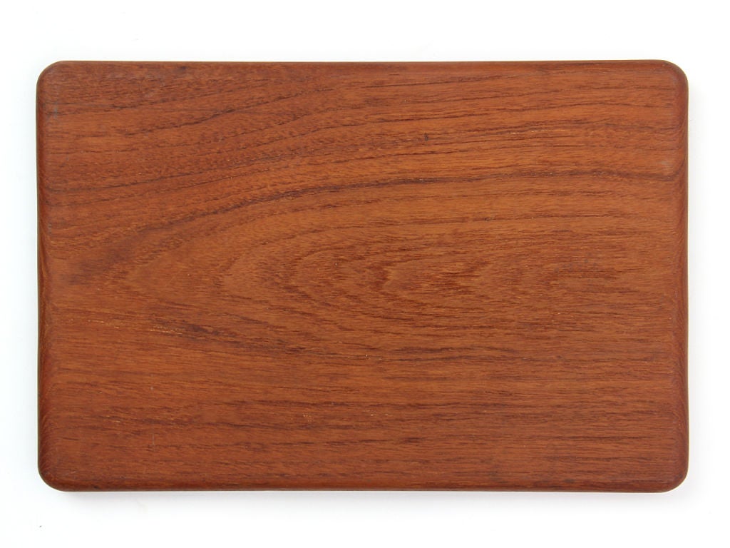 A petite teak cheese board / cutting board. Stamped 