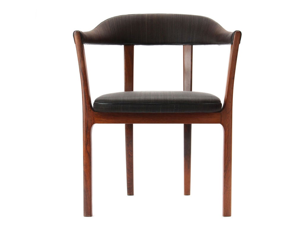A rosewood hump-backed armchair, retaining the original horsehair upholstery with black leather welting.