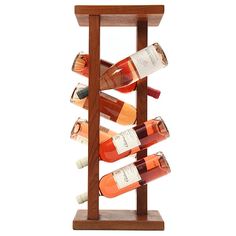 A simple and sculptural teak bottle holder for up to ten bottles of wine or spirits.