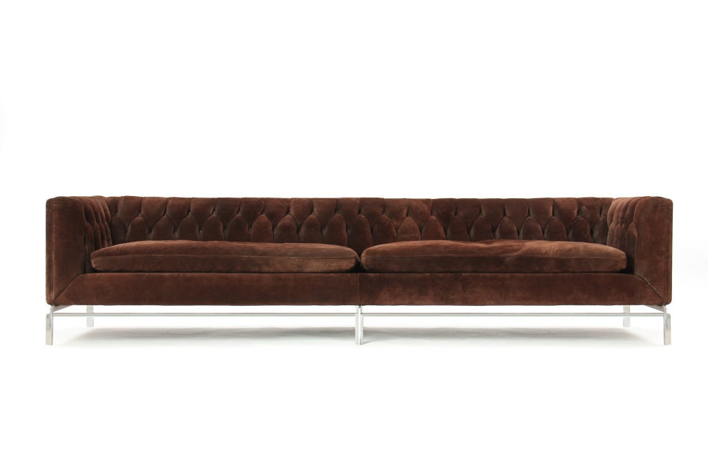 A long chesterfield sofa on a chromed steel base in the original brown suede upholstery.