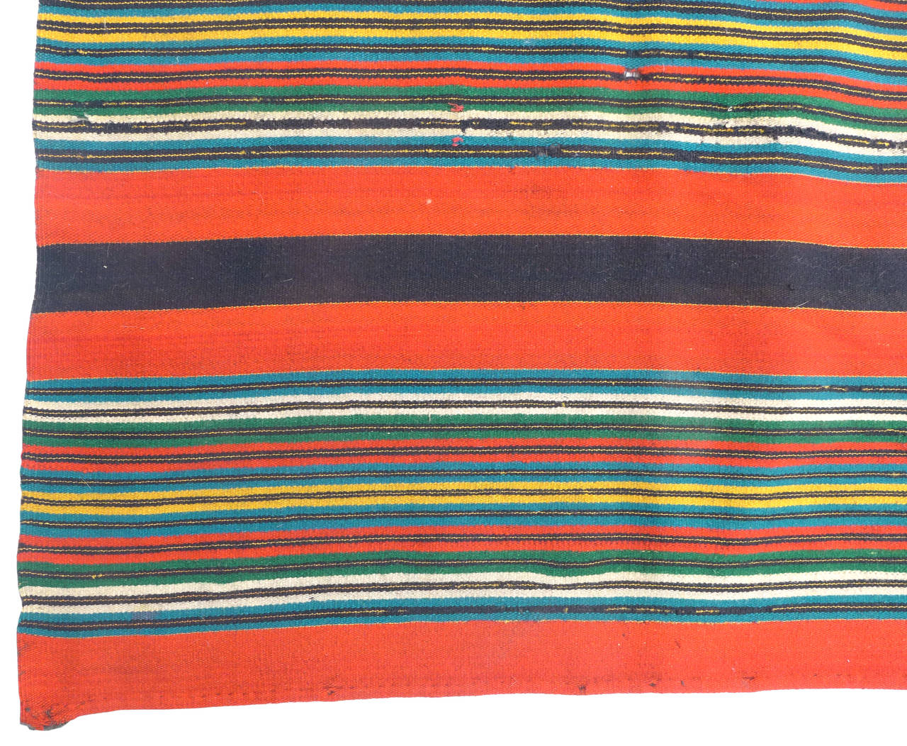 A striking, turn-of-the-century, Mexican, hand-woven textile.  A Saltillo-style weaving wearing a beautifully vibrant mix of color in a variegated, optic linear pattern.  At some point in it's life this piece was looped over at one end and gently