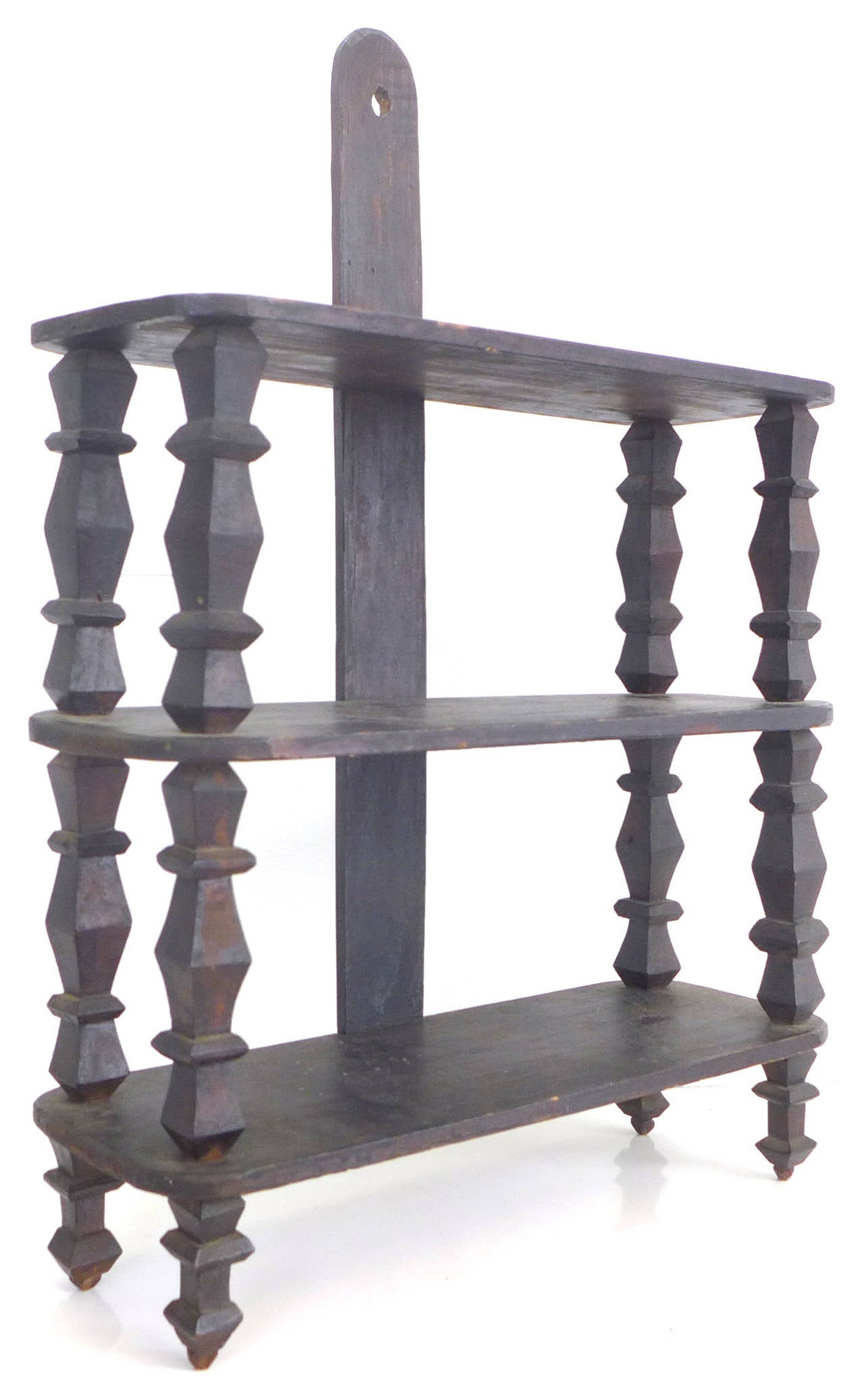 A compact, beautifully modernist, geometric, hand-carved-wood shelving unit.  Great detail and patina throughout.
