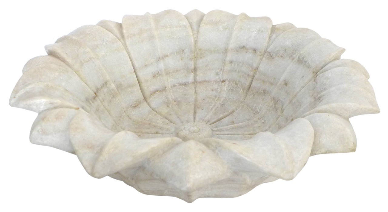 A large, beautifully-carved stone bowl in the form of a flower in full bloom.  Fantastic, deeply carved details with radiating petals reaching out to drape at the bowl's rim.