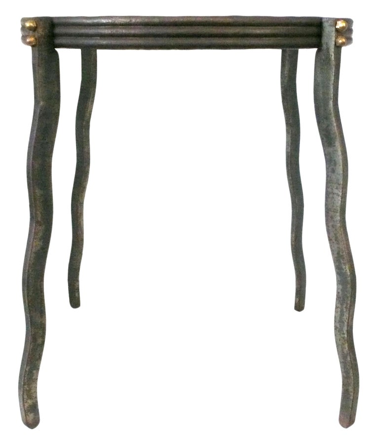 An interesting and whimsical side table in steel and glass by the New York designer, Will Stone. A wonderful form with undulating legs and brass acorn-nut details.