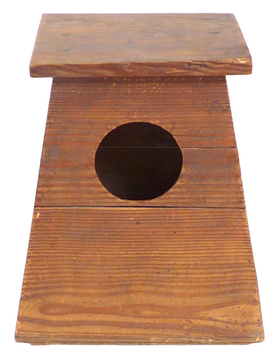 A wonderfully architectural Japanese shoeshine stool/storage-box.  A beautifully simple, hollow, flattop, monolithic form of wood slabs with a porthole cutout for interior access.  Much desired patina throughout.