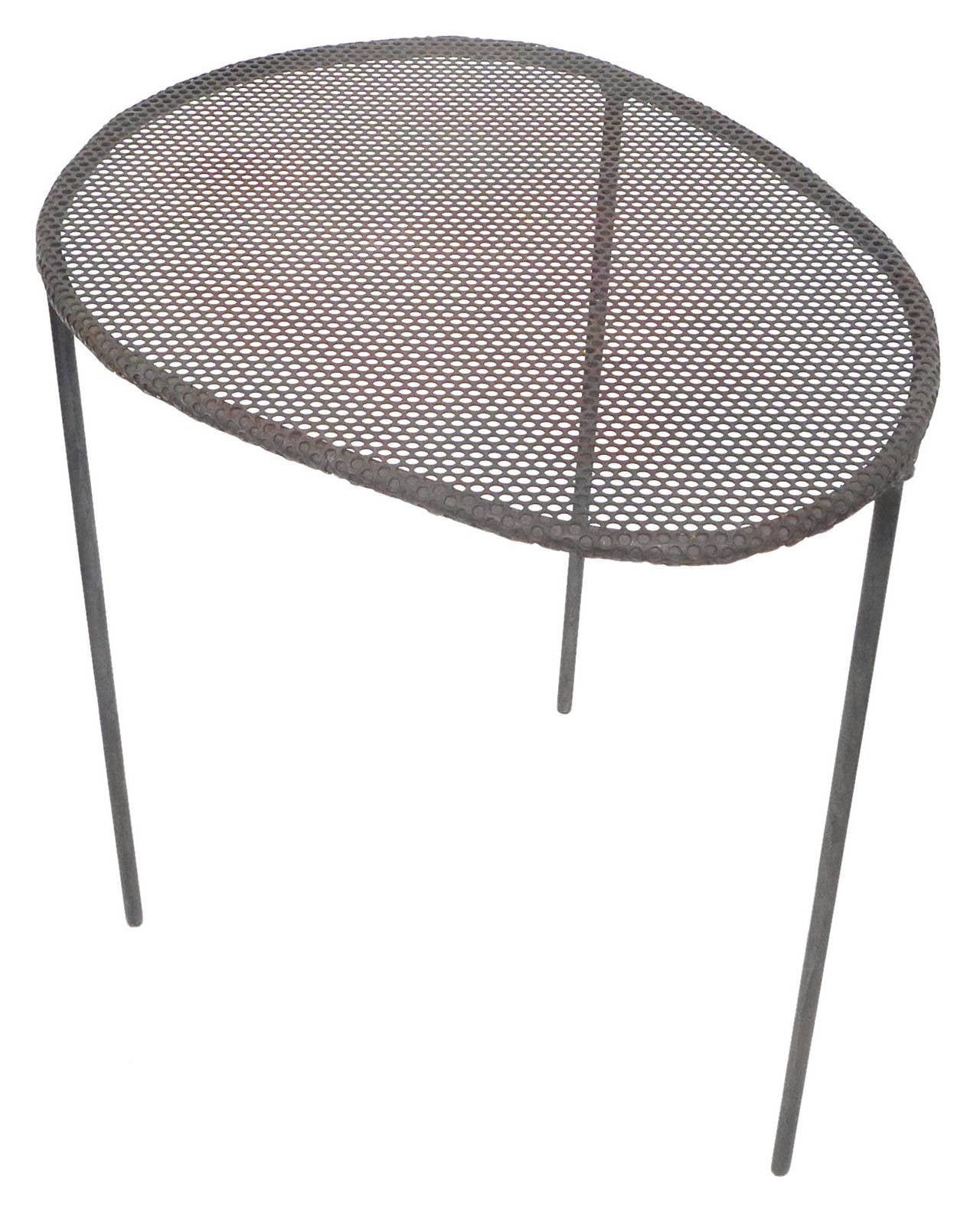 A whimsical. perforated, welded steel side table.  A wonderfully playful, slight, 3-legged, biomorphic form of unmistakable Mategot intention with a nice patina, likely from time outdoors.  A beautifully executed, alluring decorative element.