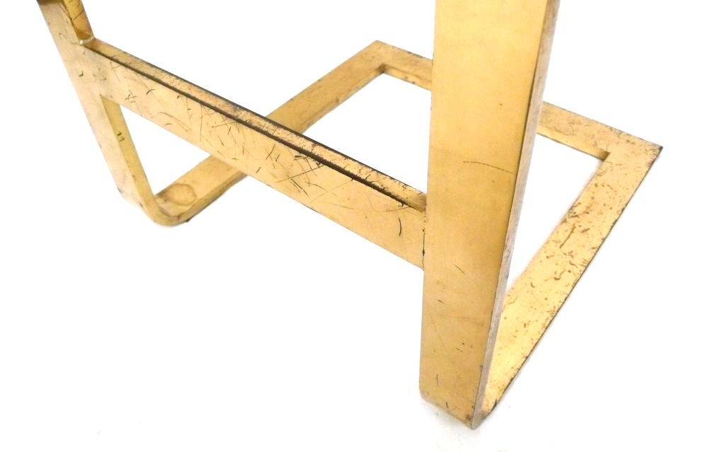 Modernist stool in heavy, flat stock brass with original leather upholstery. A strong, reduced form.