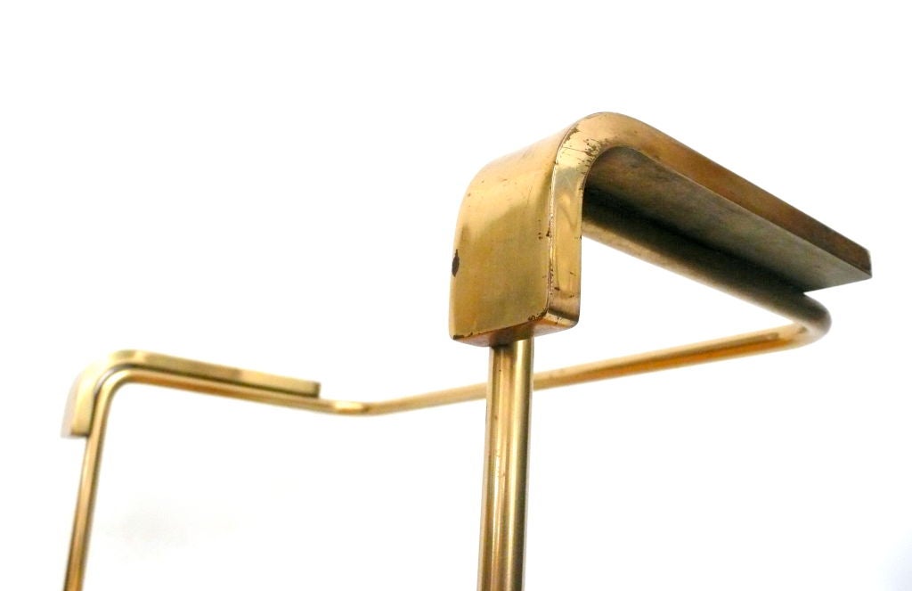 Modernist stool in heavy, flat stock brass with original leather upholstery. A strong, reduced form.