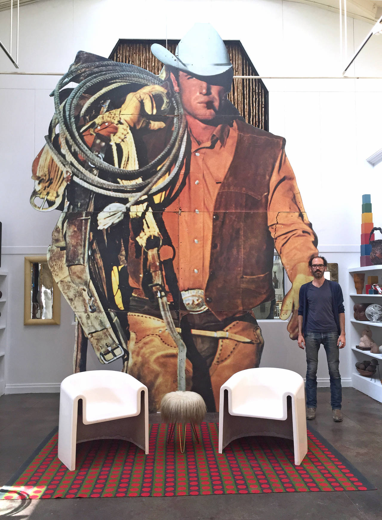 A gigantic, vintage billboard of an iconic slice of American pop culture and modern advertising genius: The Marlboro Man. Out of context and out of time, an oversized cowboy amazingly outfitted in nearly every possible western Americana