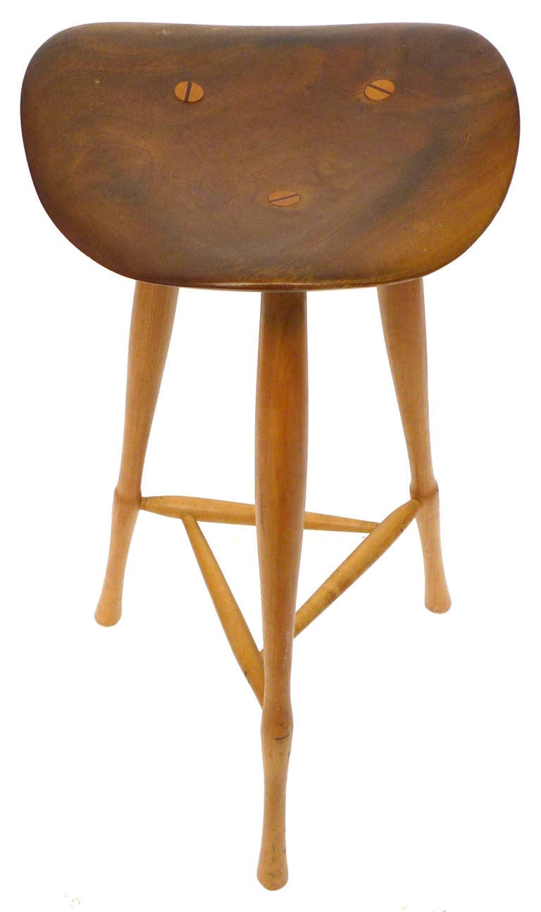 An extremely beautiful, well designed and executed American Craft stool with fantastic form and patina by Karl Seemuller.  Sculpted free-form seat with undulating, turned legs and stretcher elements as well as dowel and wedge construction. A very