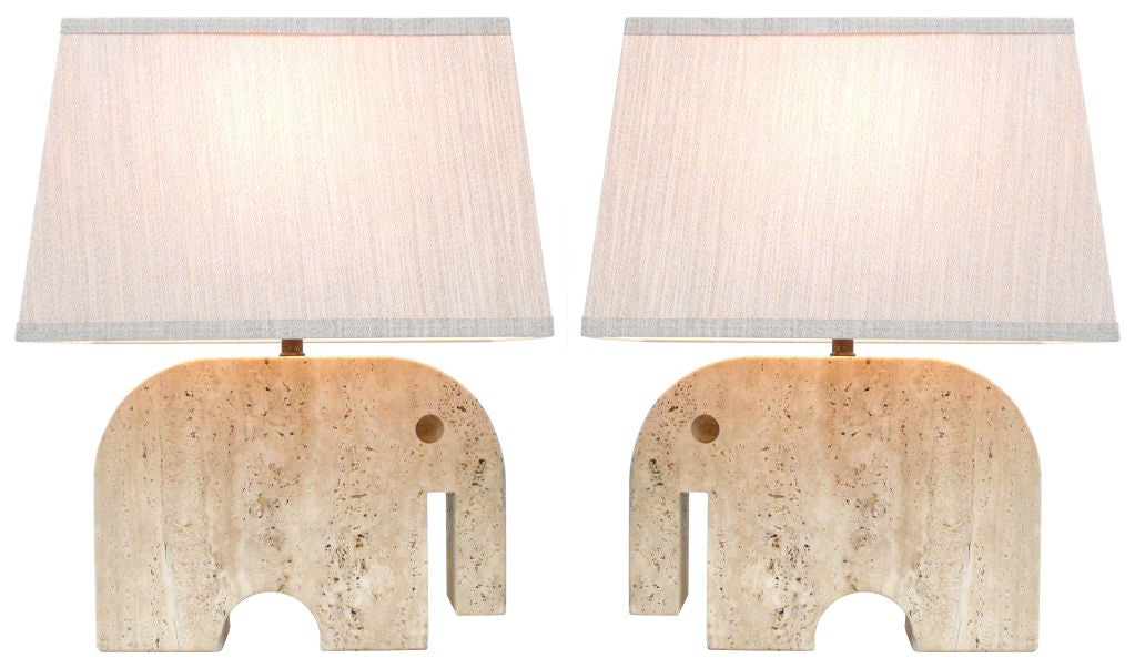 Wonderfully whimsical pair of Italian modernist travertine elephant lamps. Strong stylized stone forms rewired with all brass hardware, French twist silk cord and custom contemporary shades. Very reminiscent of the work of Enzo Mari. Distributed by