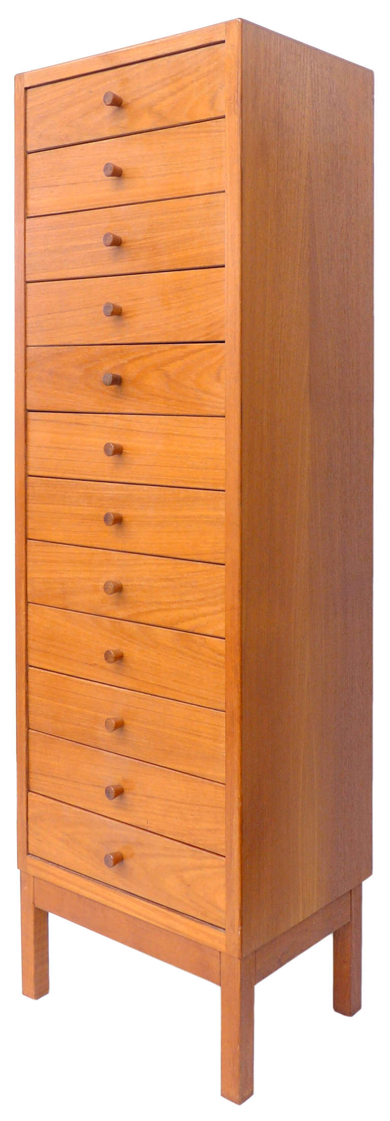 A wonderful Danish chest of drawers with fantastic scale and form made by J. Ingvard Jensen. Twelve-drawer minimalist design with beautiful construction details. A very elegant and  unusual cabinet which is both utilitarian and sculptural. Wonderful