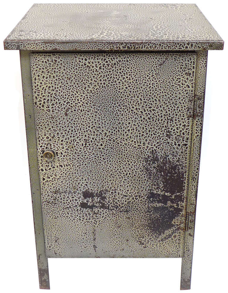 An unusually wonderful industrial cabinet in sheet steel with an exceptional alligator finish.  A perfectly simple, extremely well-built, industrial storage-piece turned strangely elegant with its inside-and-out saurian surface.  Beautifully mottled