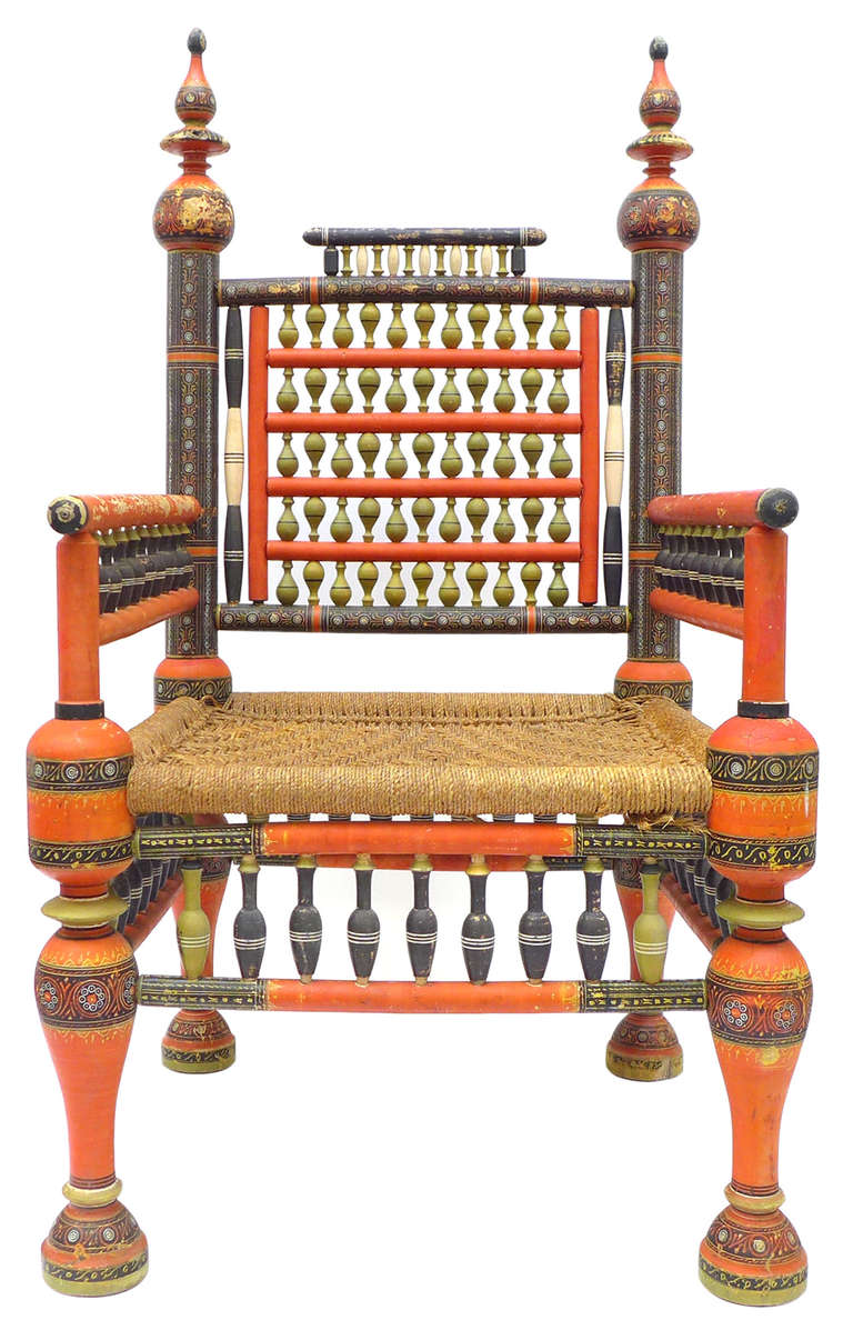 A pair of traditional Punjabi tribal chairs from Pakistan.  Brilliantly decorated with ornate hand-painted designs decorating every inch of these dramatic chairs. Seat is woven in sisal rope. Good original condition with a wonderful, gently worn