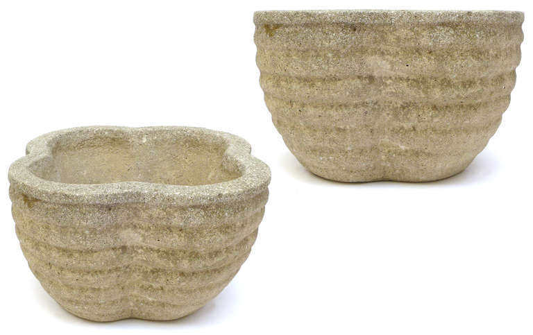 A wonderful pair of Japanese cast-concrete planters.  Stepped, corrugated clover-leaf forms with exceptional patina from years of outdoor use.  With a simple, graphically-inspired linear pattern, great examples of Japanese modernism.