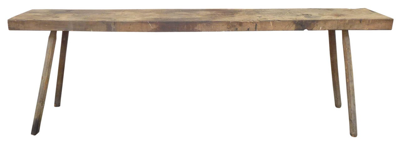 An incredible, primitive, wood console or work table.  Exceptionally long and beautifully worn from years of use.  A great surface throughout, wonderfully mottled from a mix of mediums.  Faceted, splayed legs are mortise-and-tenon jointed through to