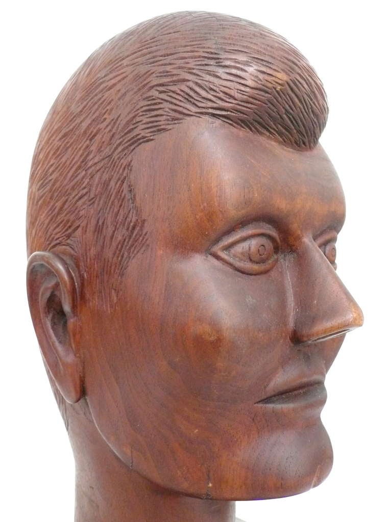 Interesting, carved-wood head by an unknown California sculptor. Wonderfully naive yet artfully representative figure that strongly appears to be JFK.  A powerful piece with a fantastic and provocative presence.