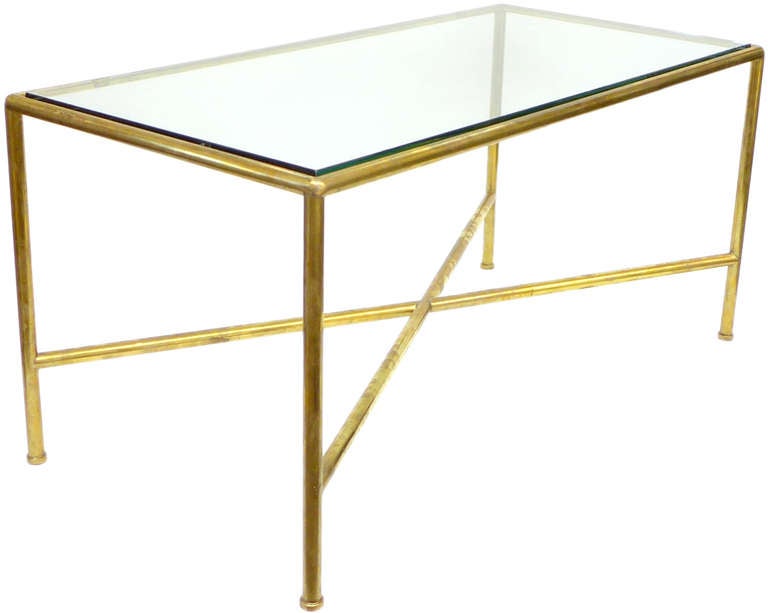 A wonderfully minimalist, custom-made tubular brass and glass coffee table. A beautifully made and simple rectilinear form with a strong, X-base cross stretcher.