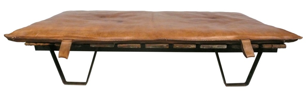 Vintage French leather gym mat with fantastic patina and character on an interesting, industrial footed-palette. A striking combination creating an unusual and dramatic daybed.