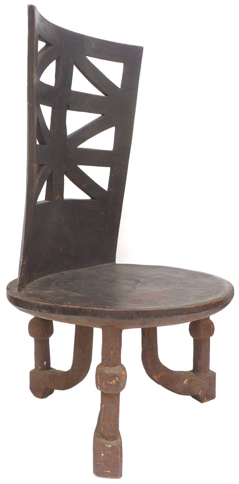 A large-scale and beautifully carved African (Ethiopia) wood throne with fantastic geometric details. A massive and powerful three-legged form, carved from a single-piece of wood. Exceptional decorative presence with a wonderful primitive meets