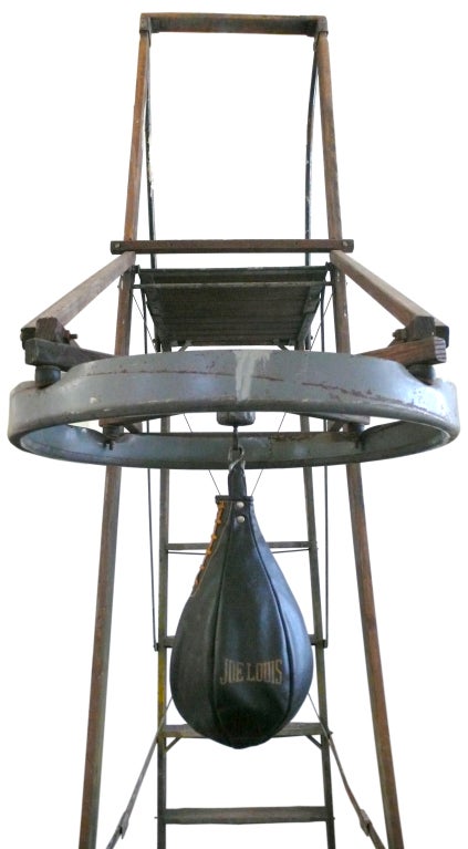 A wonderfully unusual 1940's boxing training ladder and speed-bag, as found in a Texas boxing gym. The boxing bag appears to have been rigged to the ladder long ago, with a perch to accommodate a coach keeping his eye on his fighter's form from