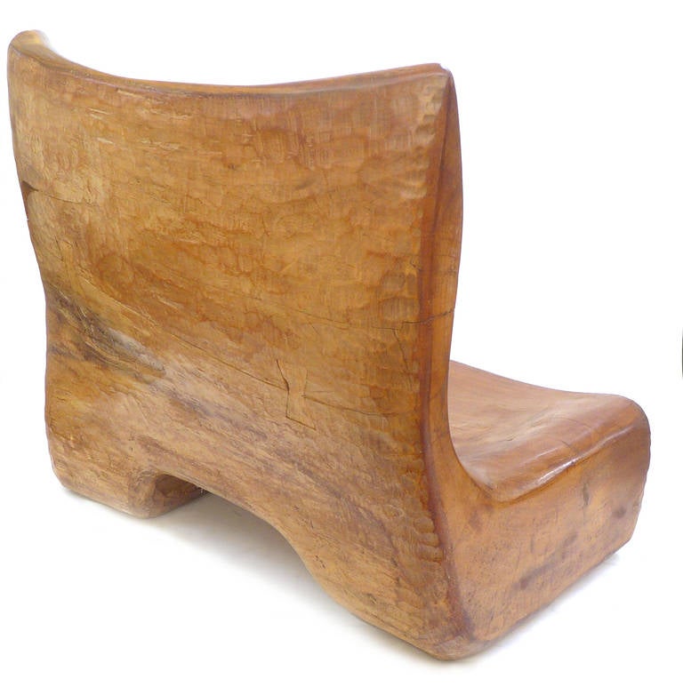 Discovered in an East Coast Marcel Breuer designed home, this spectacular chair was chisel-carved from a solid piece of wood. Incredible scale, form and execution. Wonderful bow-tie joint reinforcement detail on back and subtly beautiful surface