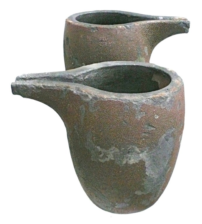 A fantastic and unusual pair of large, solid graphite foundry crucibles, used for pouring molten bronze. Exceptionally beautiful and decorative vessels with great character and presence. Wonderful surface with bronze 