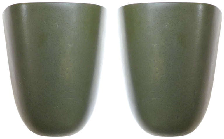 An unusual and utilitarian design by Malcom Leland for Architectural Pottery. Designed to be wall-mounted or free-standing, these architectural vessels were meant to be used as either planters or ash receivers. A wonderful form and rich, green glaze.