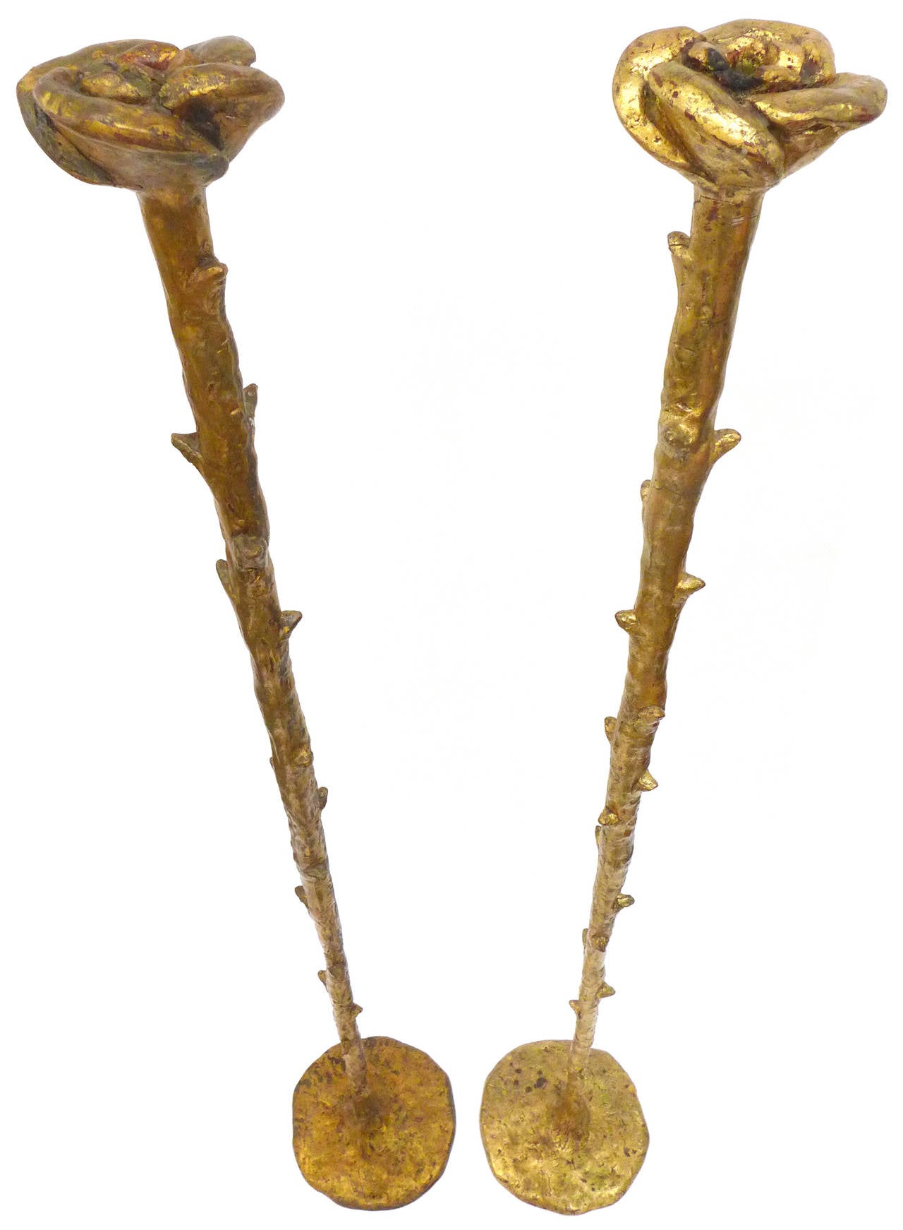 A beautiful pair of gold-leaf standing candlesticks.  Composed of cast resin, wonderfully exaggerated, Giacometti-like, stylized forms of a single rose atop a thick, throned rose-branch.  A perfect patina of subtle crazing throughout.  Great and