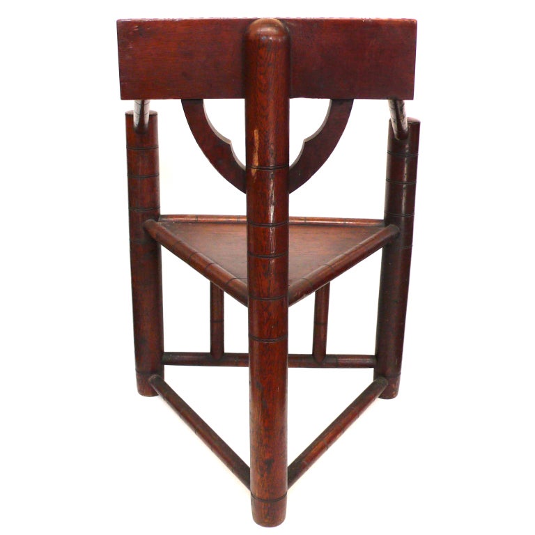An unusual and interesting 3-legged, neo-gothic chair with fantastic, hand-carved details. A very graphic and geometric chair with an Arts & Crafts and Modernist feel.