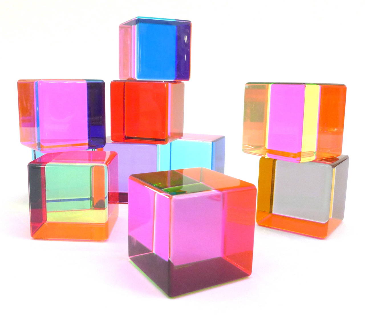 A terrific, vintage set of 10 colorful, laminated lucite cubes by celebrated Los-Angeles-based artist Vasa Mihich.  Brilliantly-hued, alluring and wonderfully playful objects that can be displayed in an endless variety of ways, changing color with a