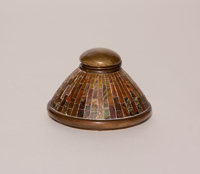 A Tiffany Studios bronze inkwell with glass tesserae and glass liner, signed.