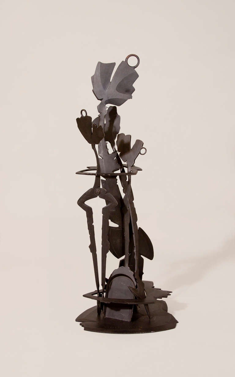A set of patinated steel fire tools designed by Albert Paley, comprising a stand, poker, tongs and shovel, signed and dated.