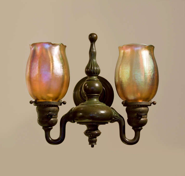 One of a set of four, this Tiffany Studios Double Sconce features two gold iridescent Tiffany Favrile Glass 