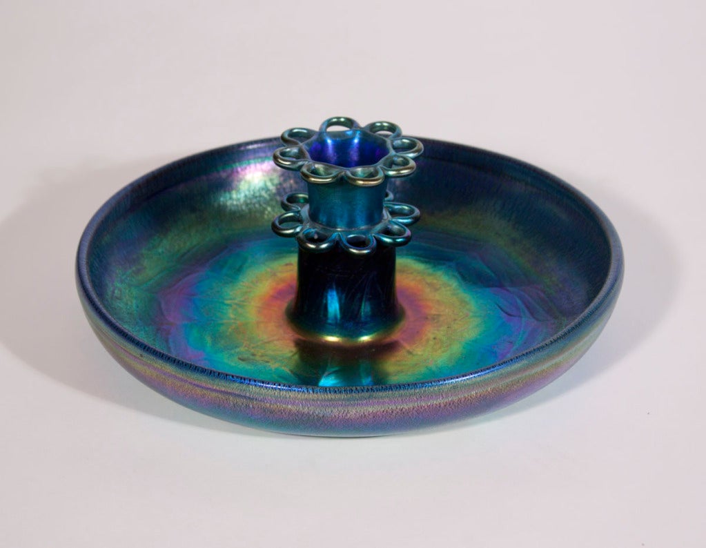 A Tiffany Studios iridescent favrile glass flower frog and bowl with textured peacock feather design, signed.