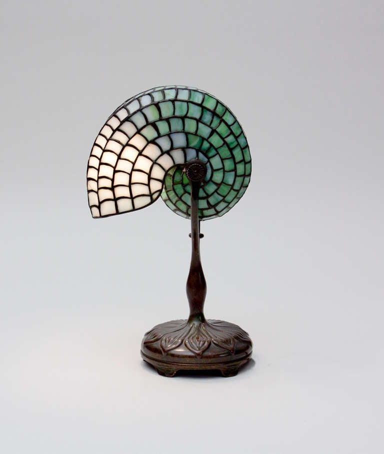 A Tiffany Studios Leaded Glass Nautilus Desk Lamp with bronze base, signed.