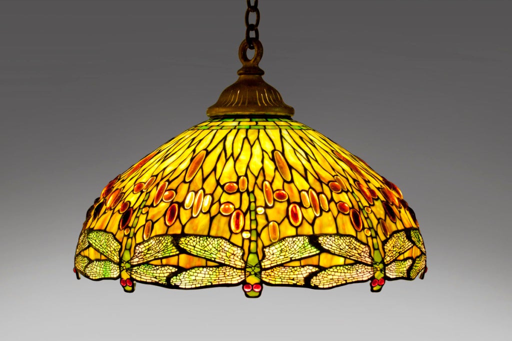 A Tiffany Studios Drophead Dragonfly leaded glass and bronze hanging shade, the leading with aged gilt finish.