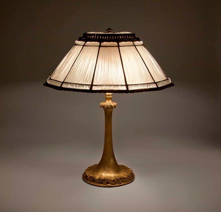 A Tiffany Studios leaded glass and bronze lamp comprising a 