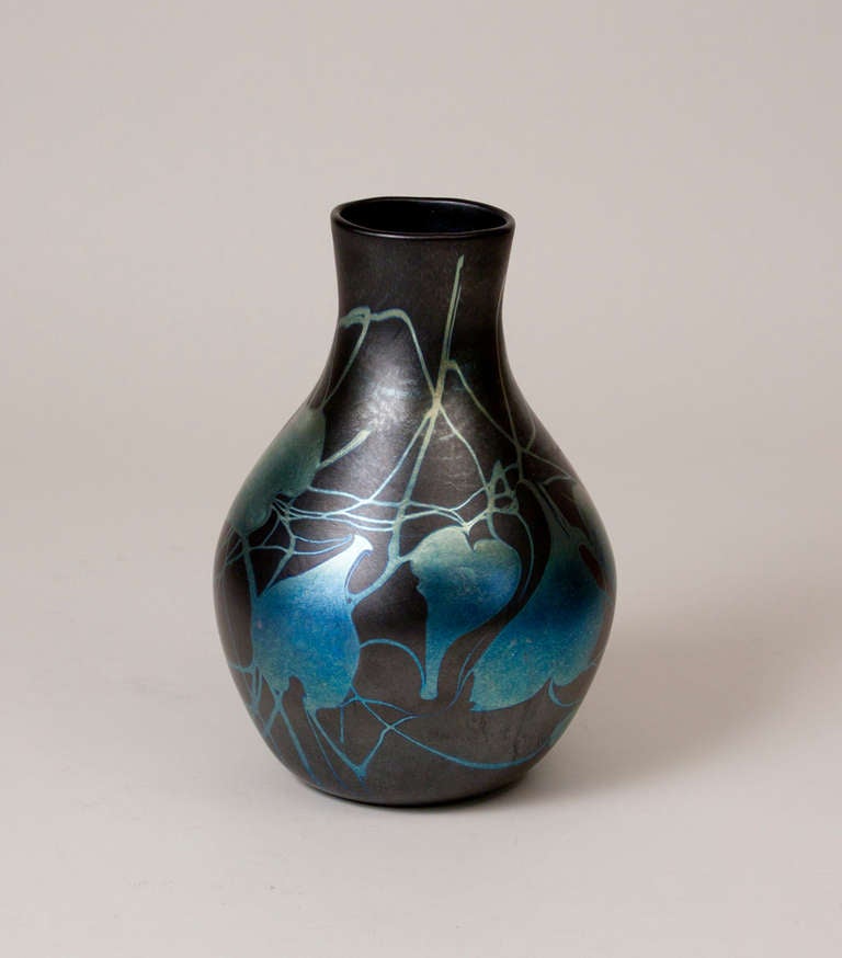 A Tiffany Studios Favrile Glass Vase with mirrored leaf and vine decoration on a black ground, signed. 

Illustrated: 

Martin Eidelberg, Tiffany Favrile Glass and the Quest of Beauty, New York: Lillian Nassau LLC, 2007. p. 38