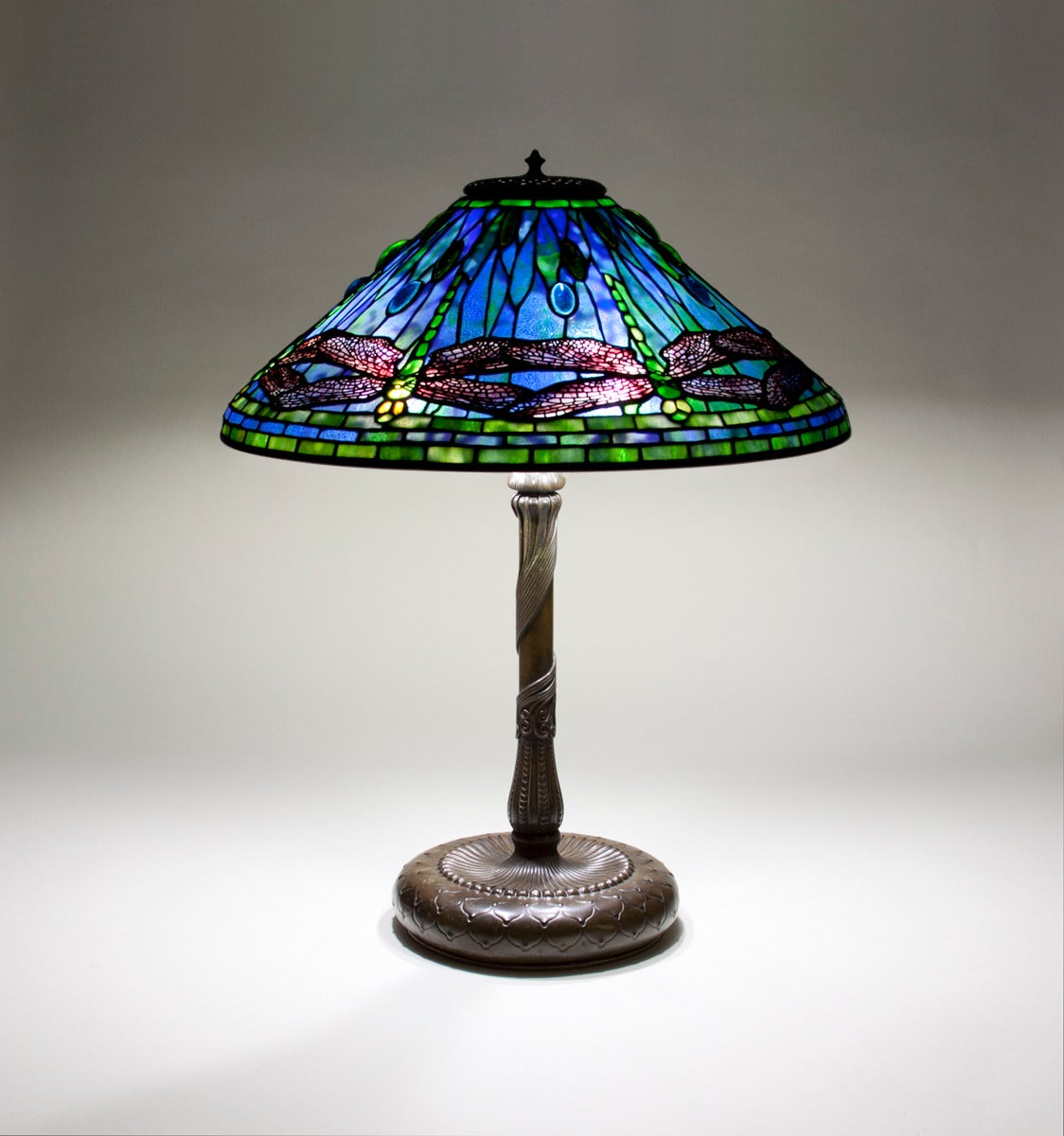 A Tiffany Studios leaded glass and bronze table lamp comprising a 