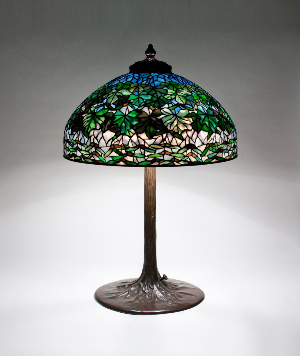 A Tiffany Studios leaded glass and bronze table lamp comprising a 